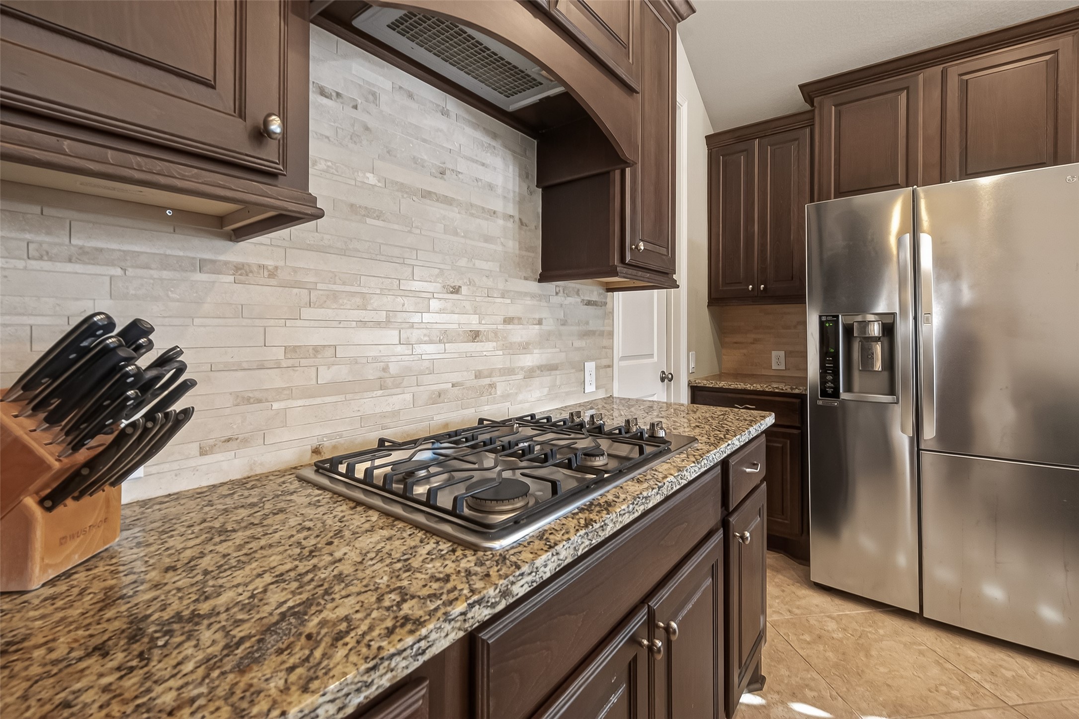 28435 Sycamore Falls Lane Fulshear, TX 77441 - Photo 18 of 46 a kitchen with a stove and a refrigerator