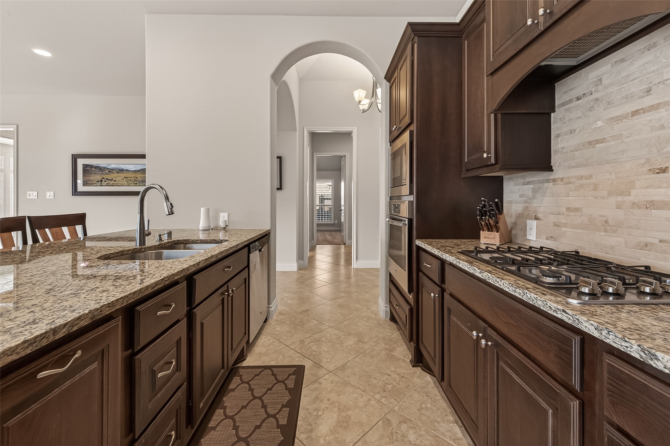28435 Sycamore Falls Lane Fulshear, TX 77441 - Photo 20 of 46 a kitchen with granite countertop a sink stove and cabinets