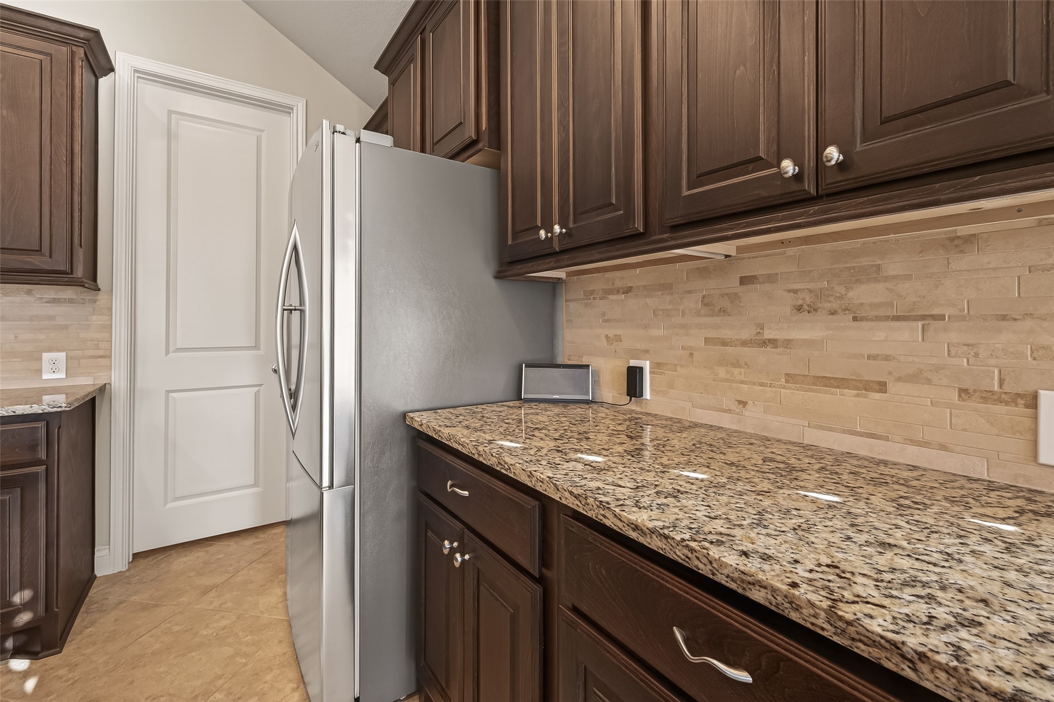 28435 Sycamore Falls Lane Fulshear, TX 77441 - Photo 22 of 46 a kitchen with granite countertop cabinets and refrigerator