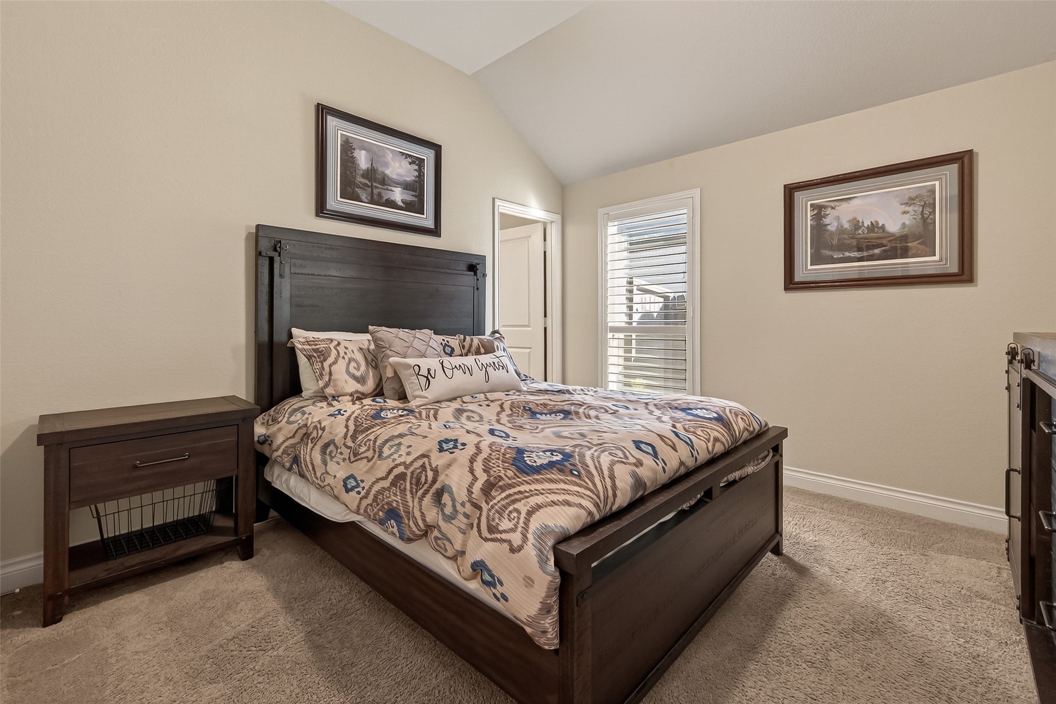 28435 Sycamore Falls Lane Fulshear, TX 77441 - Photo 27 of 46 a bed sitting in a bedroom next to a window with a baby bed