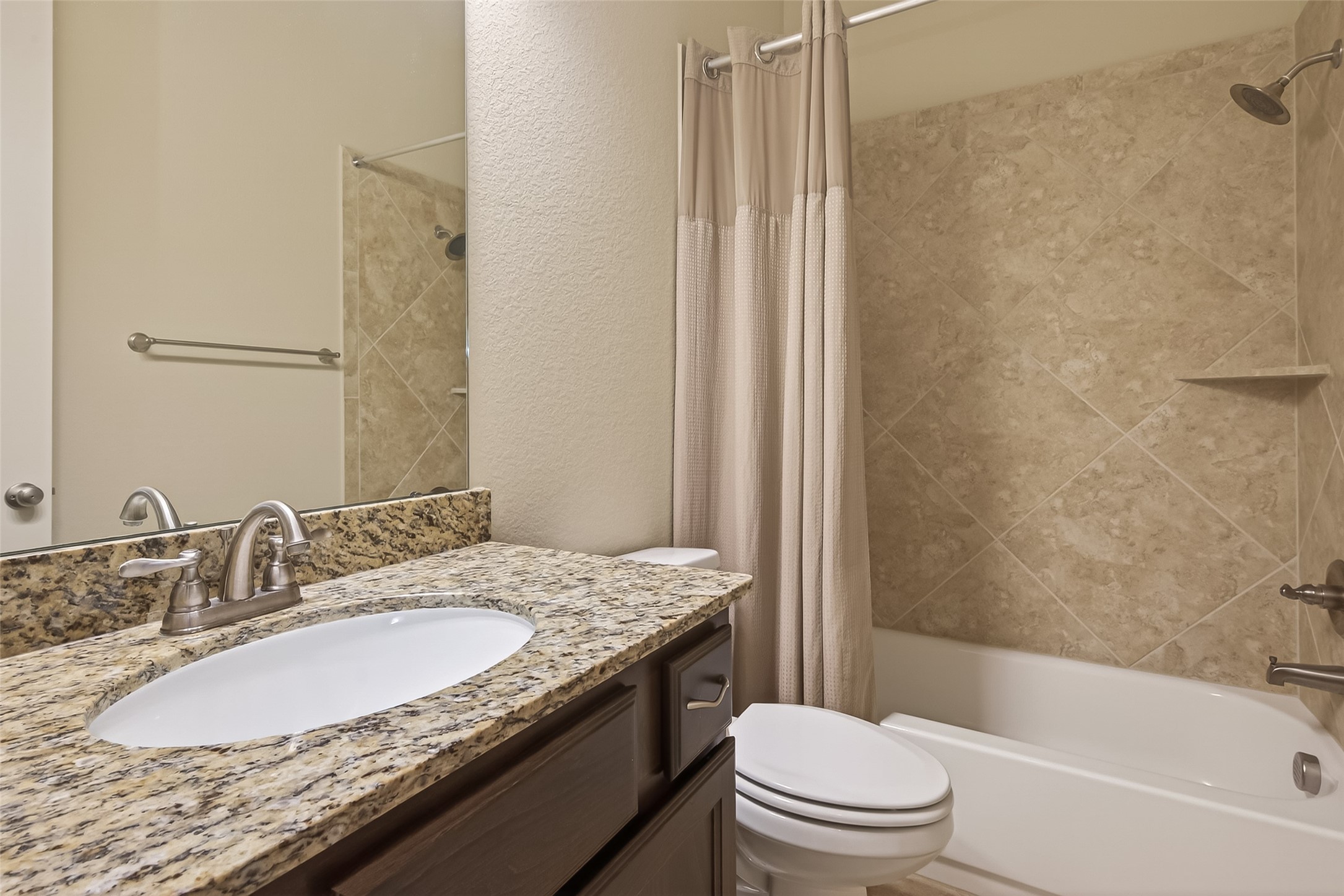 28435 Sycamore Falls Lane Fulshear, TX 77441 - Photo 28 of 46 a bathroom with a granite countertop sink toilet and shower