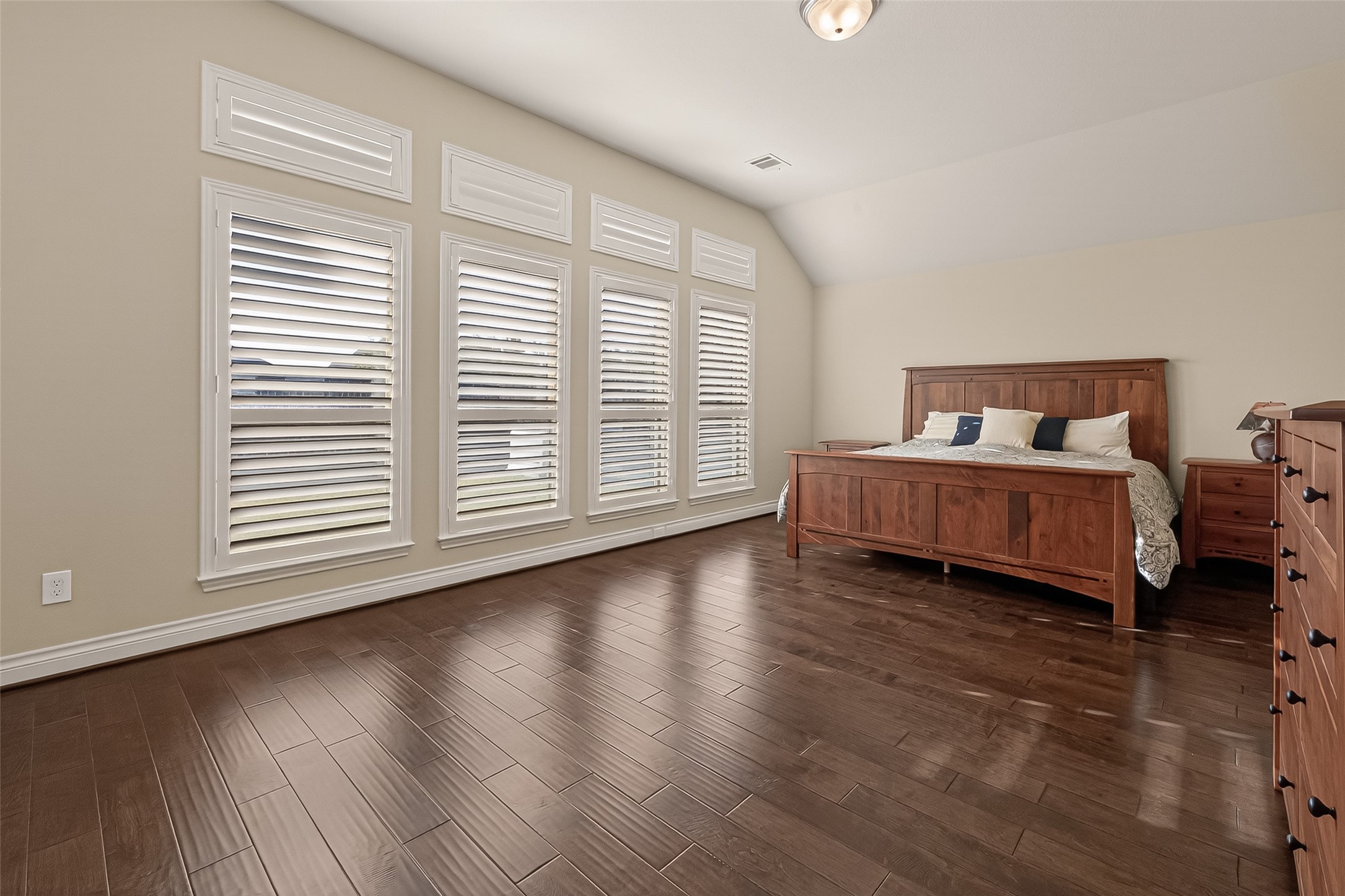 28435 Sycamore Falls Lane Fulshear, TX 77441 - Photo 35 of 46 a spacious bedroom with a bed and wooden floor