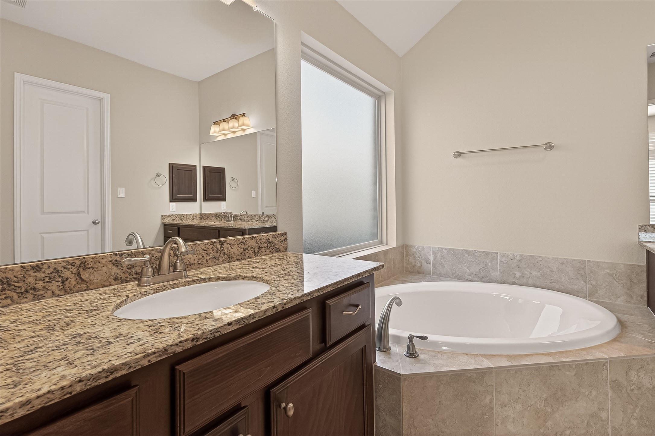 28435 Sycamore Falls Lane Fulshear, TX 77441 - Photo 41 of 46 a bathroom with a granite countertop sink and a mirror