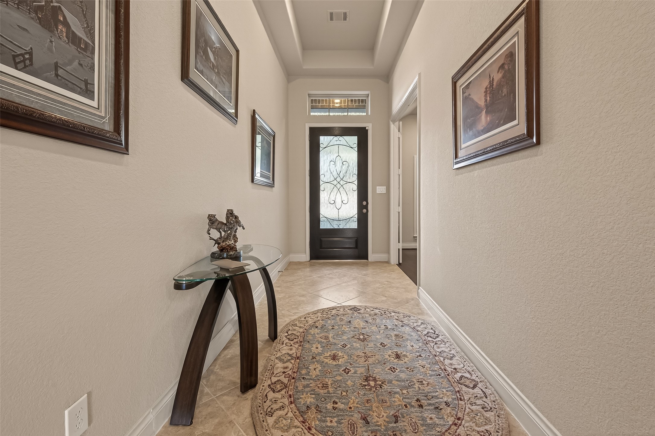 28435 Sycamore Falls Lane Fulshear, TX 77441 - Photo 5 of 46 a view of a hallway with a chandelier
