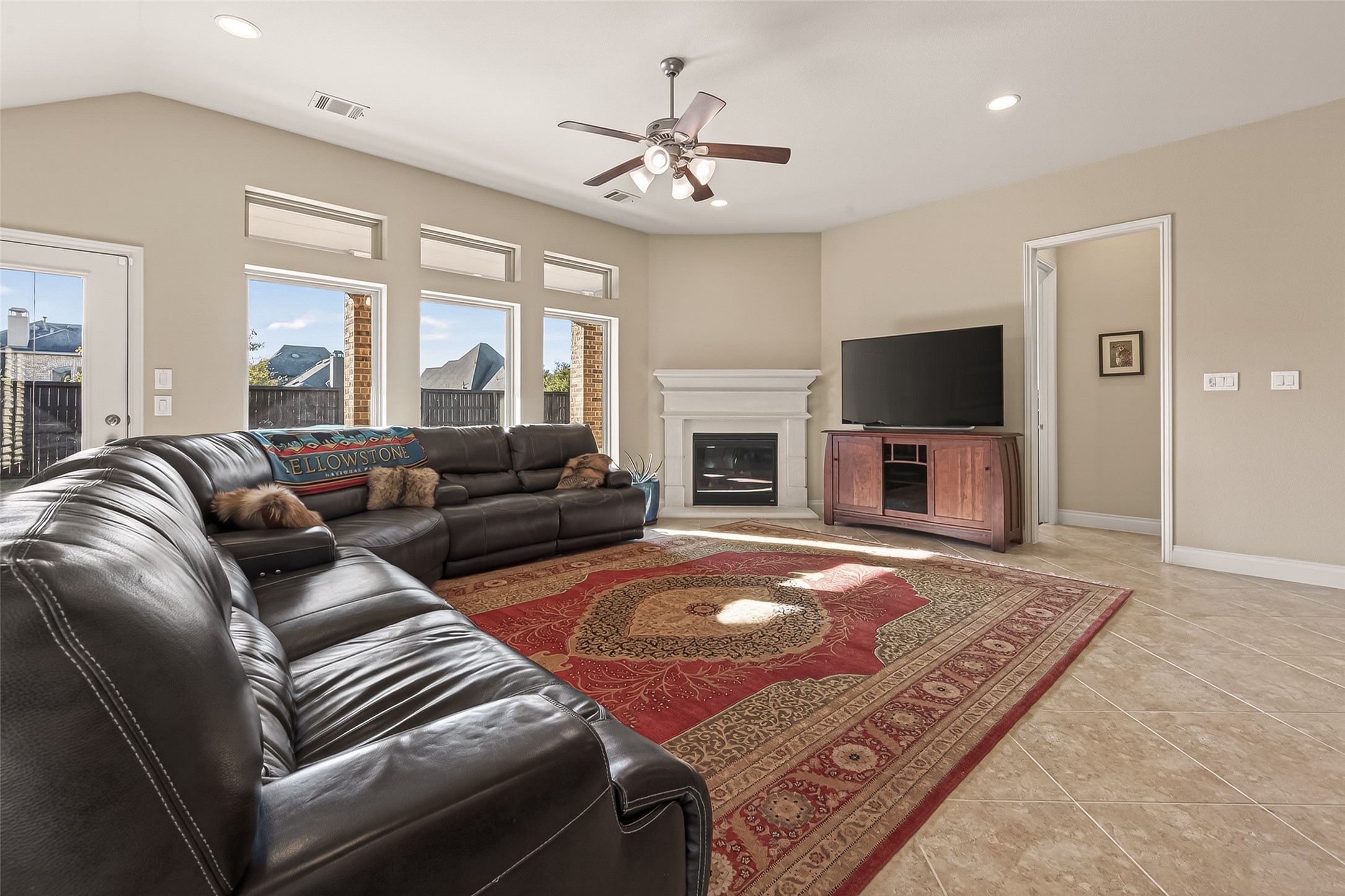 28435 Sycamore Falls Lane Fulshear, TX 77441 - Photo 8 of 46 a living room with furniture a fireplace and a flat screen tv
