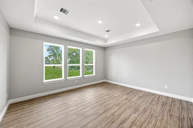 wooden floor in an empty room with a window