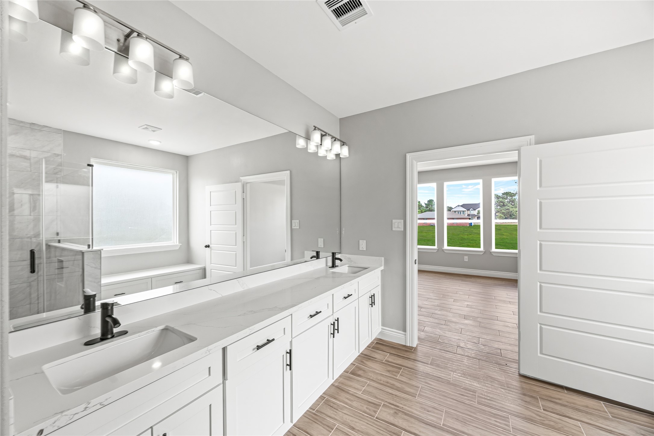 513 Oleander Street Waller, TX 77484 - Photo 16 of 28 a spacious bathroom with a double vanity sink mirror and double