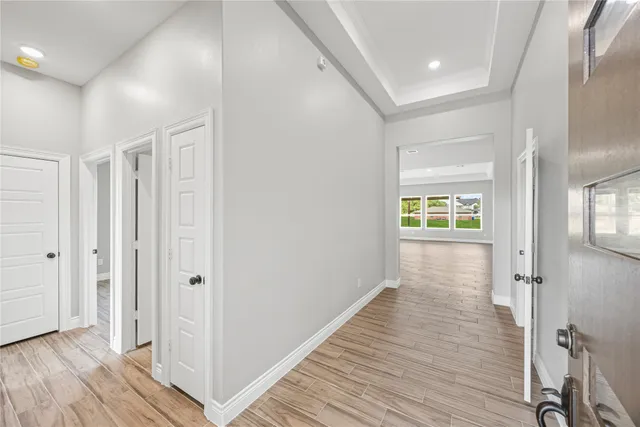 a view of hallway with wooden floor