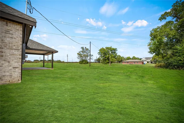 a view of yard with swimming pool outdoor seating and green space