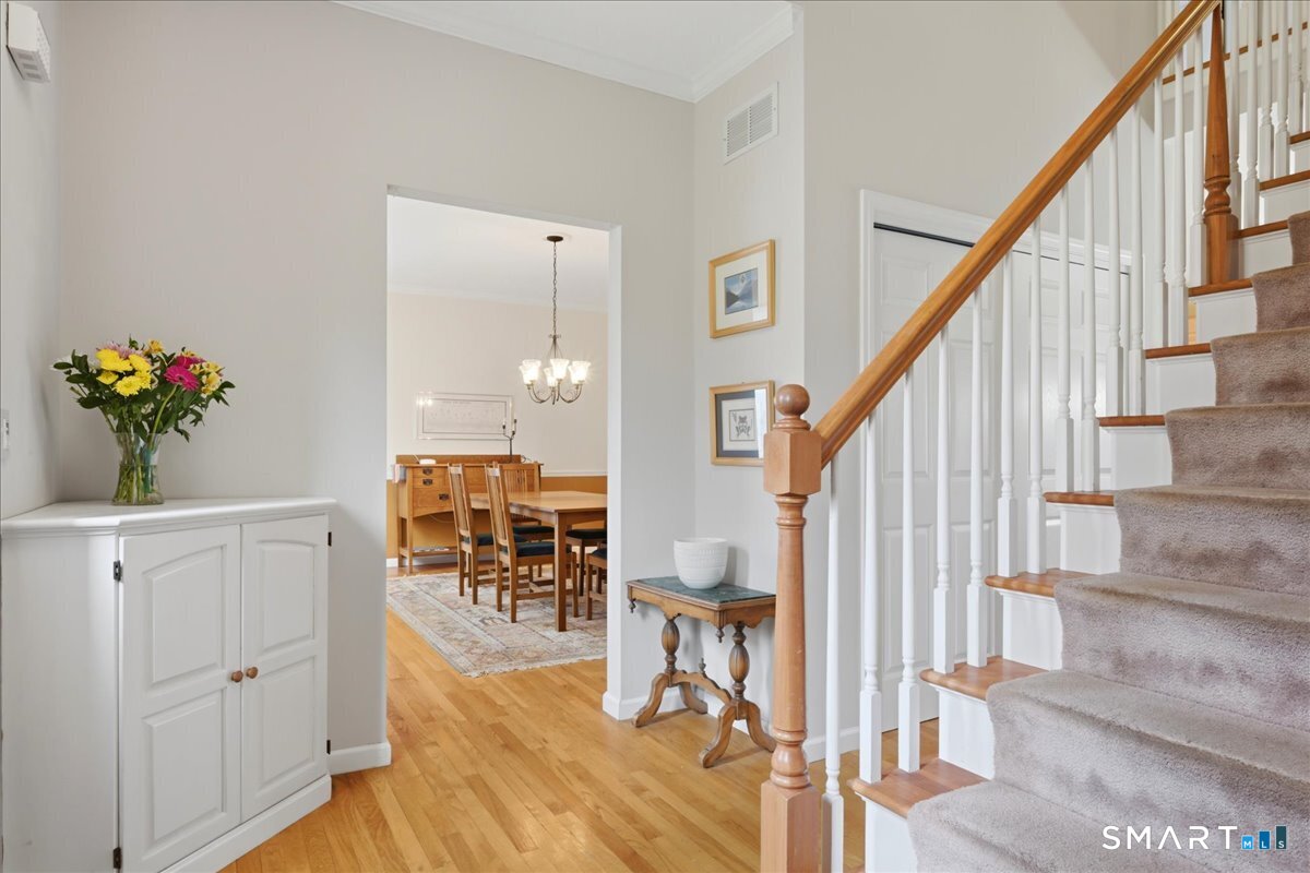 99 Sleepy Hollow Road East Lyme, CT 06357 - Photo 11 of 40 Inviting entry with built in corner cabinet opens to dining and living room areas.