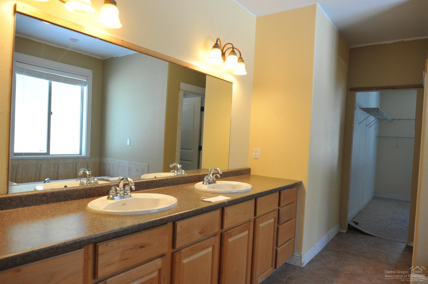 19100 Choctaw Road Bend, OR 97702 - Photo 12 of 19 a bathroom with a sink and a mirror