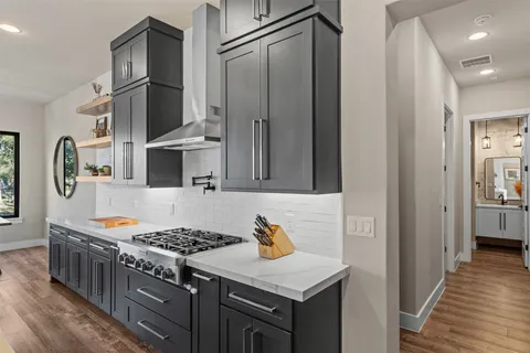 a kitchen with stainless steel appliances granite countertop a stove and a refrigerator