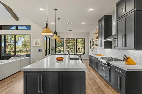 a kitchen with stainless steel appliances a sink a stove and a refrigerator