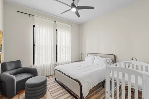 a bedroom with a bed couch and a window