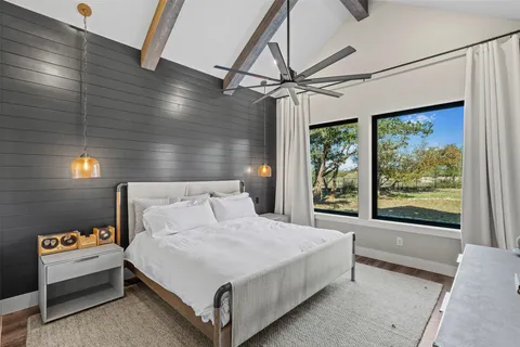 a bedroom with a large bed and a large window