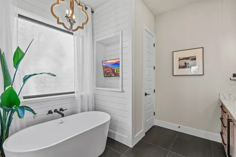 a bathroom with a bathtub and a shower