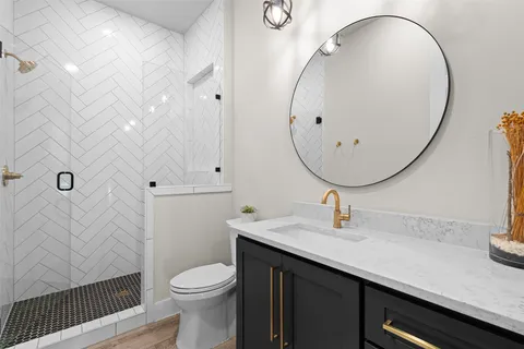 a bathroom with a sink a toilet and a mirror