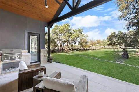 a view of a porch with furniture and garden
