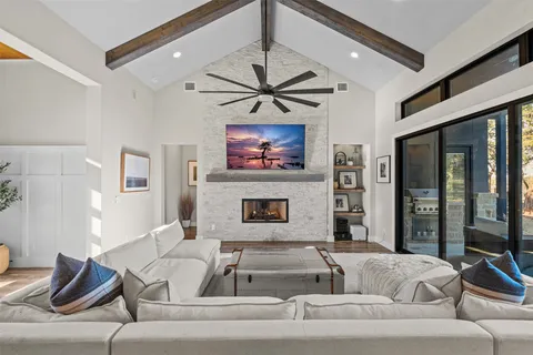 a living room with furniture ceiling fan and a fireplace