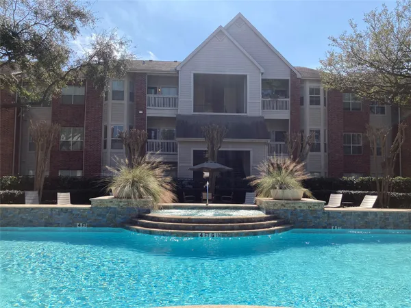 a view of a house with backyard and a patio