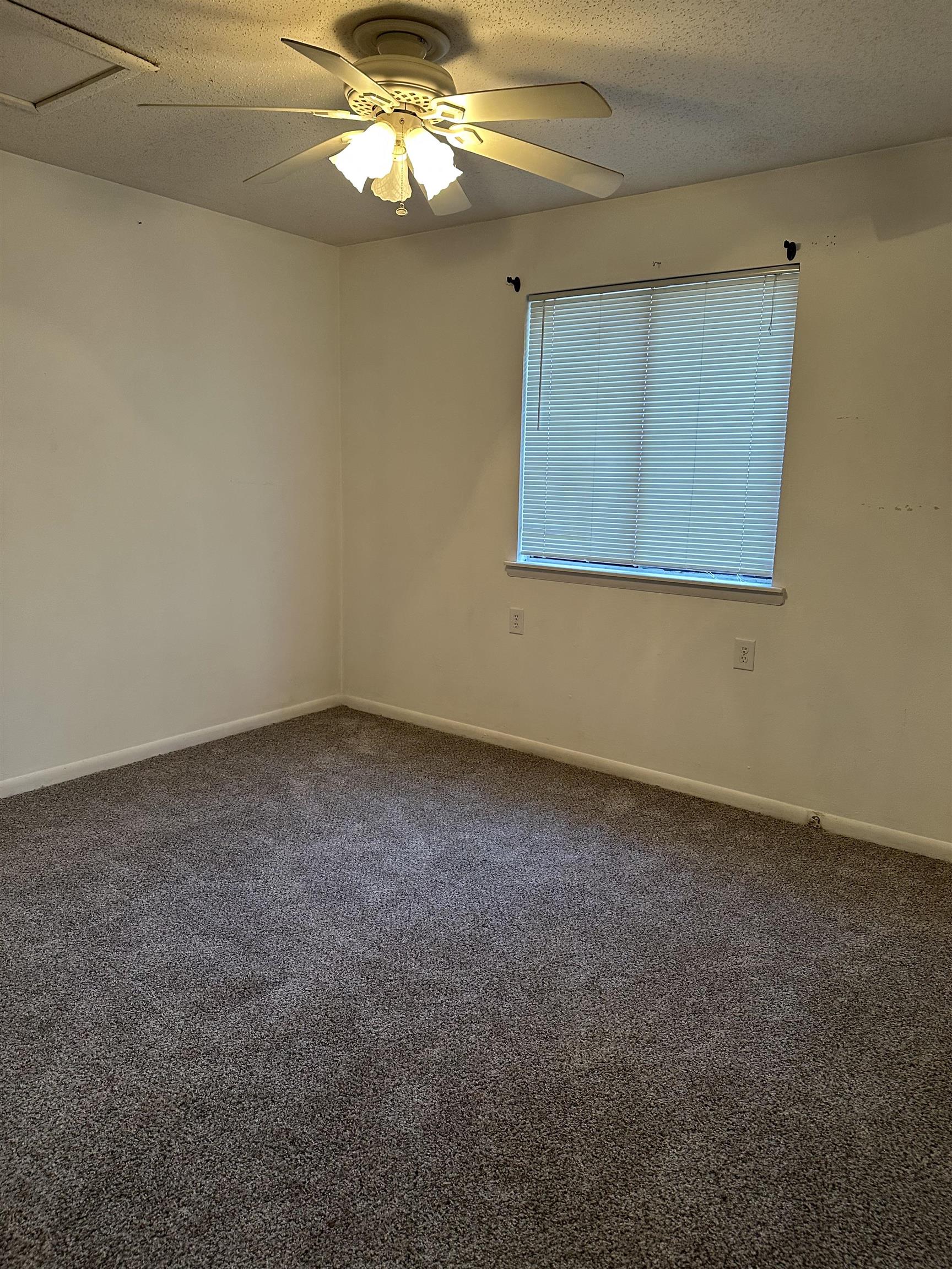3555 Highway 544, Unit 18G Conway, SC 29526 - Photo 6 of 11 Spare room featuring a textured ceiling, dark carpet, and a ceiling fan