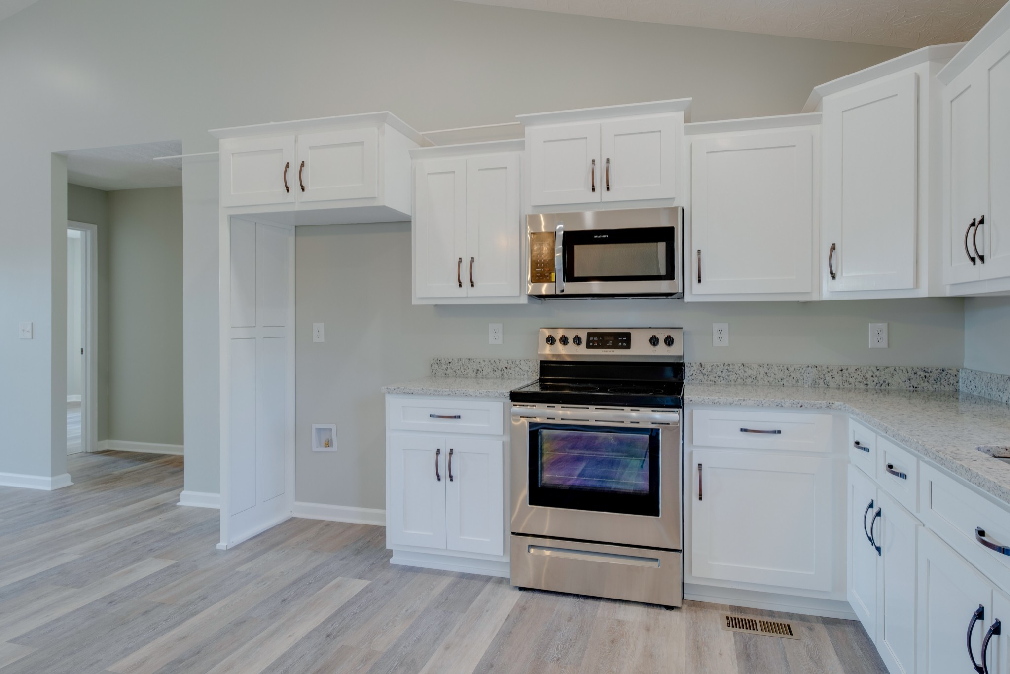 125 Vivian Lane Carthage, TN 37030 - Photo 12 of 30 a kitchen with cabinets stainless steel appliances and wooden floor