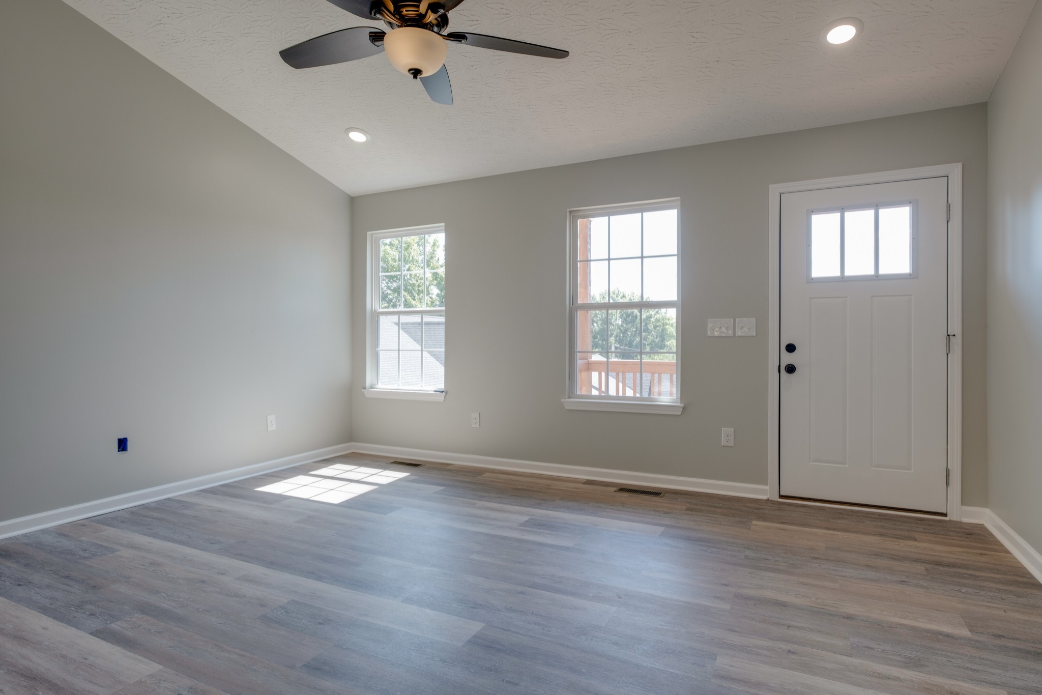 125 Vivian Lane Carthage, TN 37030 - Photo 6 of 30 a view of an empty room with a window and wooden floor
