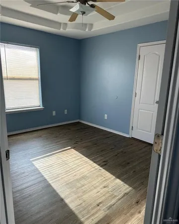 a view of hallway with wooden floor
