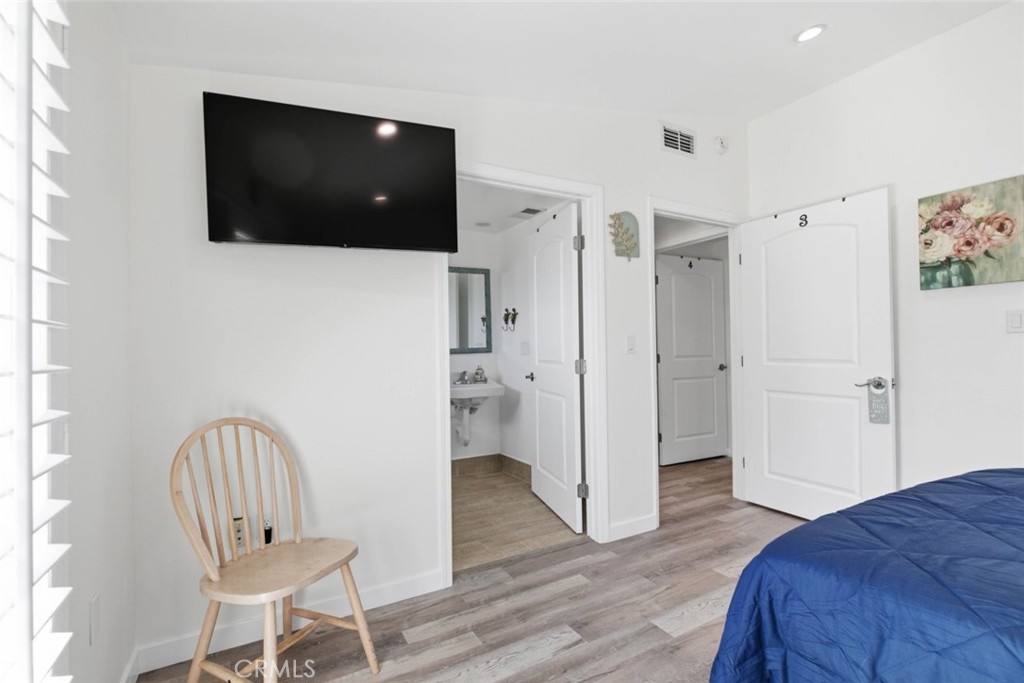 301 West Ashby Street Azusa, CA 91702 - Photo 60 of 75 a bedroom with a chair and a flat screen tv