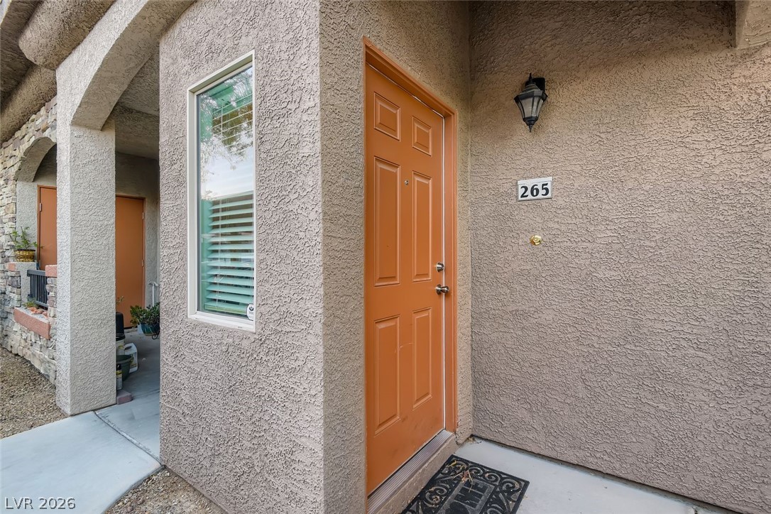 7701 West Robindale Road, Unit 265 Las Vegas, NV 89113 - Photo 3 of 27 Welcoming entryway framed by clean stucco finishes and a private sheltered entrance.
