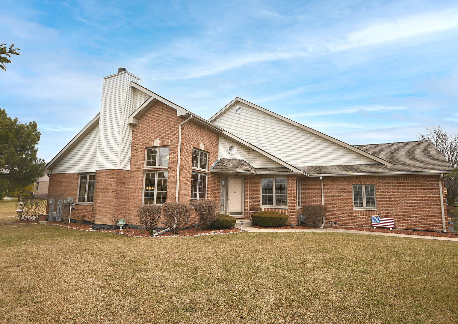 a view of a yard in front of a house with wooden fence
