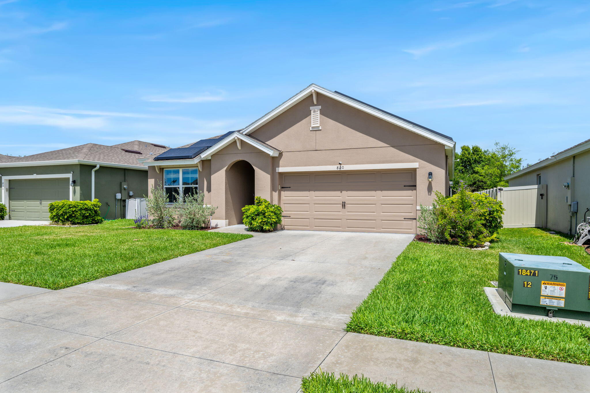 820 Forest Trace Circle Titusville, FL 32780 - Photo 1 of 27 a front view of a house with a yard and garage