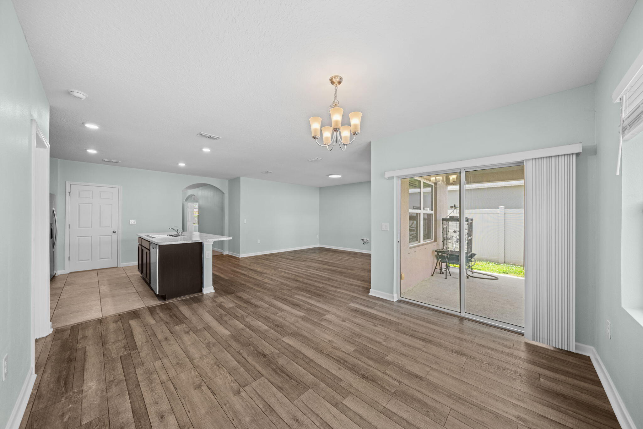 820 Forest Trace Circle Titusville, FL 32780 - Photo 14 of 27 wooden floor with an empty room and kitchen with wooden floor