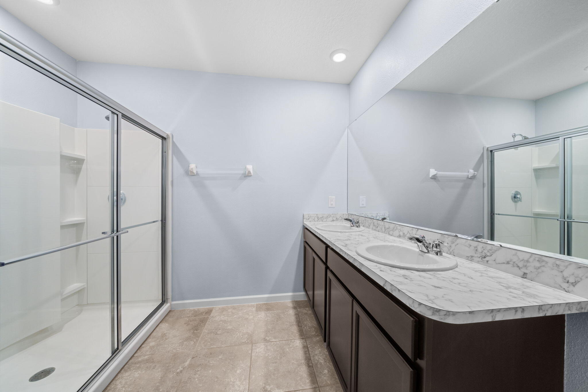 820 Forest Trace Circle Titusville, FL 32780 - Photo 19 of 27 a bathroom with a granite countertop sink a mirror and a shower