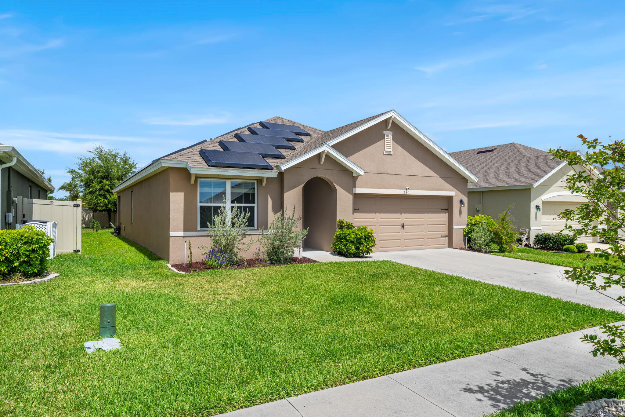 820 Forest Trace Circle Titusville, FL 32780 - Photo 5 of 27 a front view of a house with a garden and yard