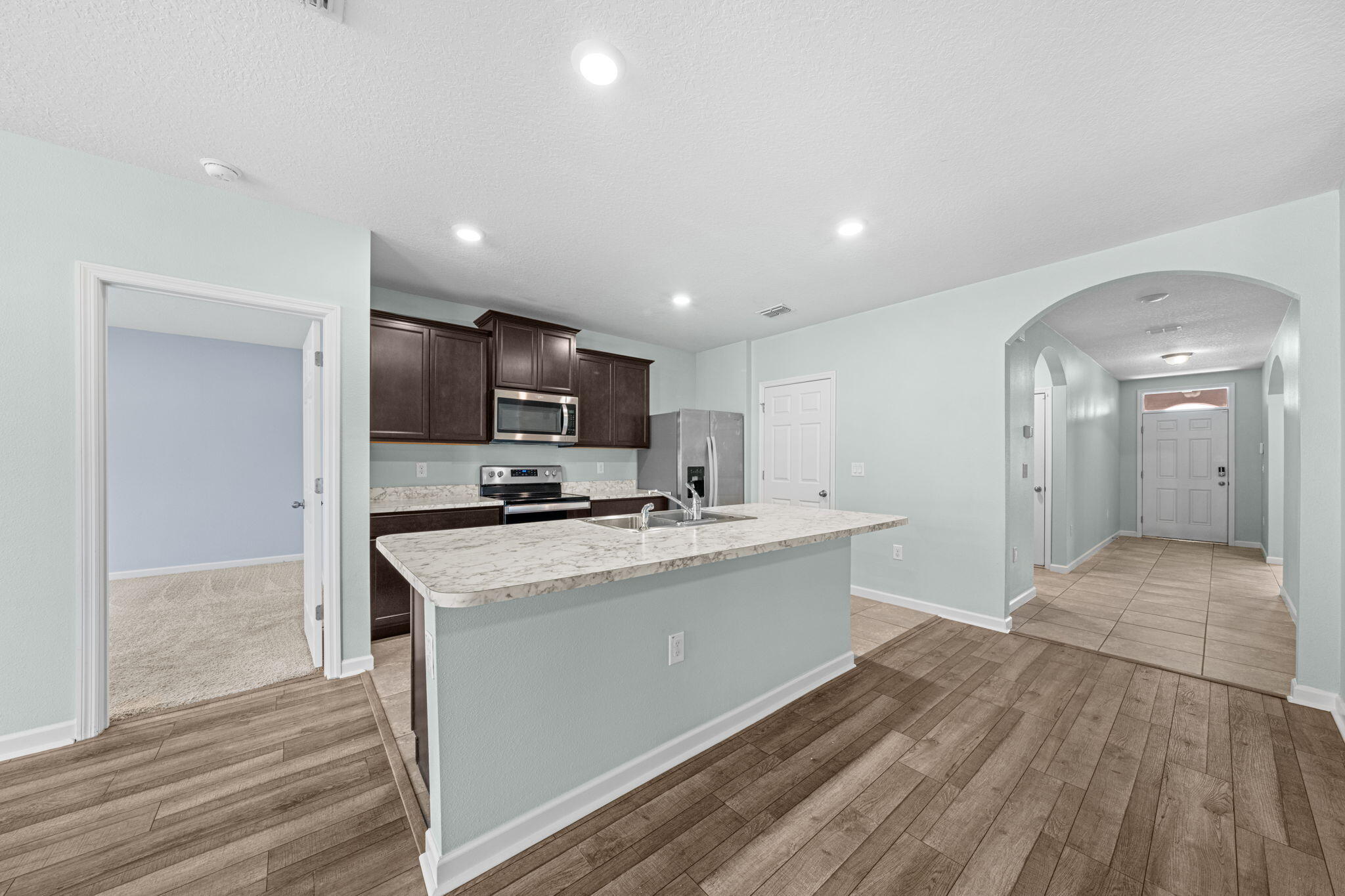 820 Forest Trace Circle Titusville, FL 32780 - Photo 10 of 27 a kitchen with stainless steel appliances granite countertop a sink a stove and a refrigerator