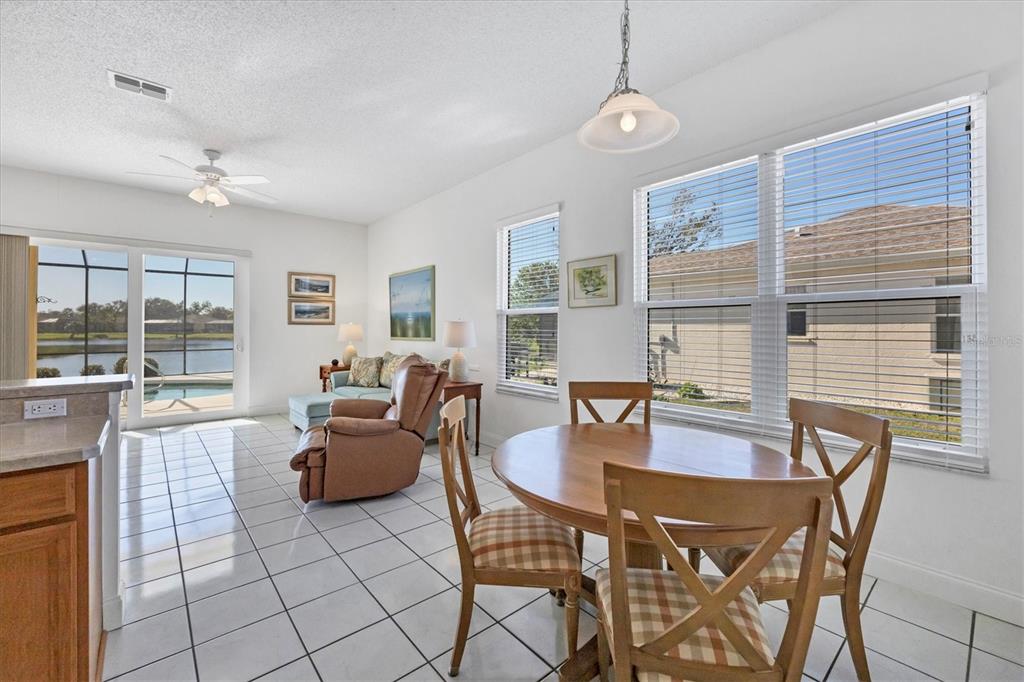 4115 Hemingway Drive Venice, FL 34293 - Photo 13 of 41 a dining room with furniture and large windows