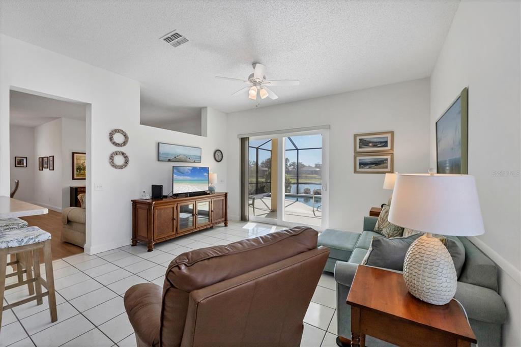 4115 Hemingway Drive Venice, FL 34293 - Photo 14 of 41 a living room with furniture and a flat screen tv