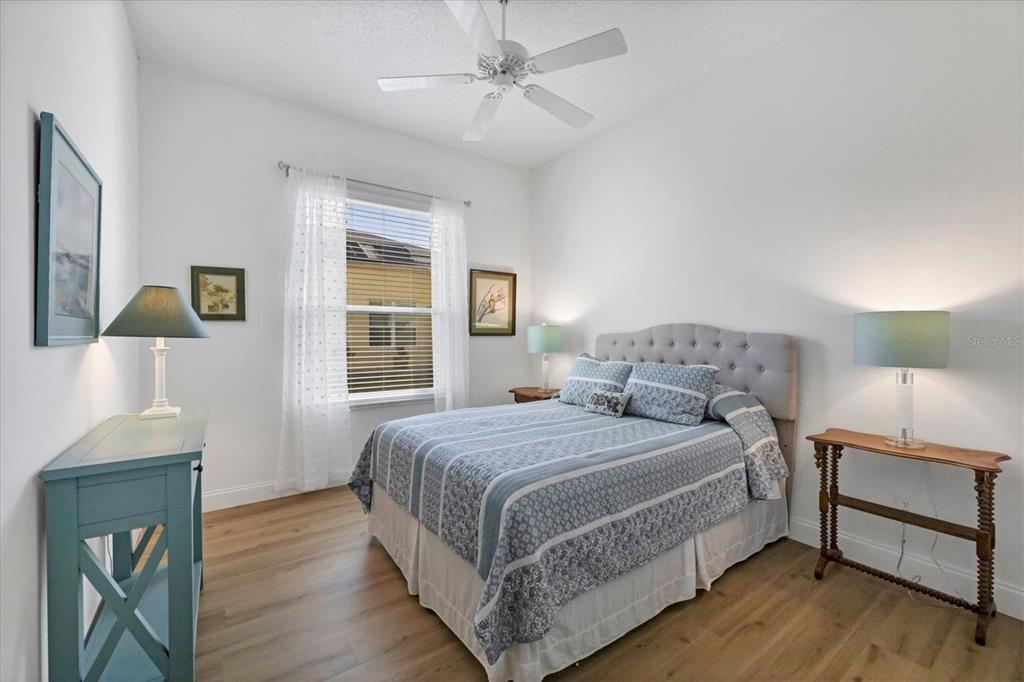 4115 Hemingway Drive Venice, FL 34293 - Photo 21 of 41 a bedroom with a bed and a lamp on a dresser