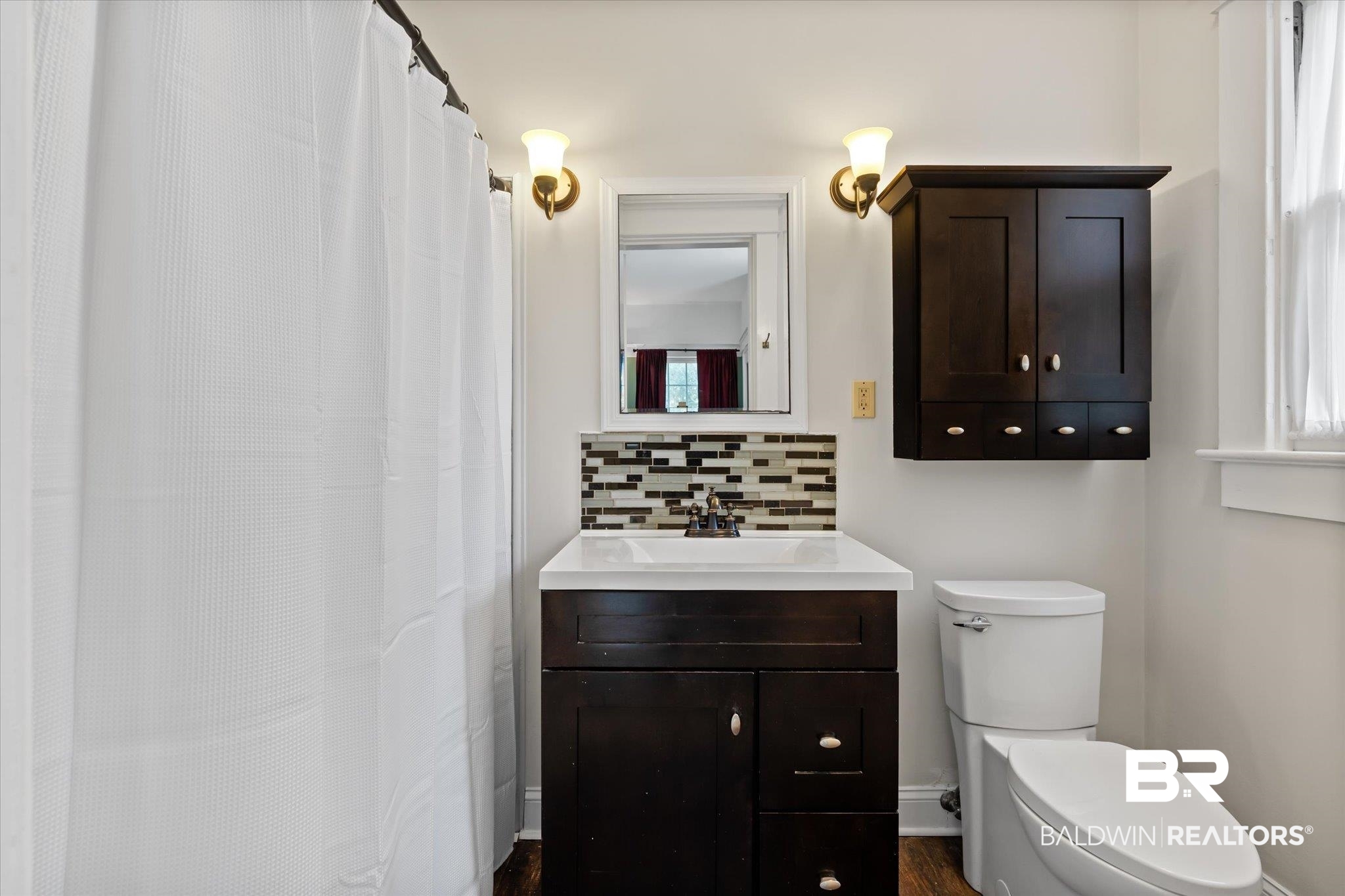 1953 Dauphin Street Mobile, AL 36606 - Photo 21 of 56 Bathroom with hardwood / wood-style flooring, vanity, toilet, and tasteful backsplash