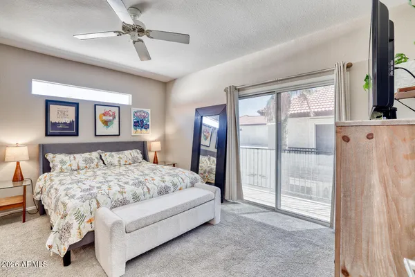 a bedroom with a large bed and a chandelier