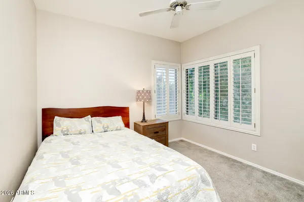 a bedroom with a large bed and a large window