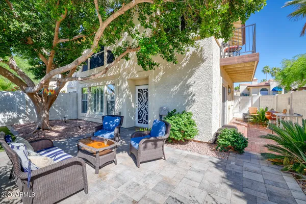 a backyard of a house with outdoor seating