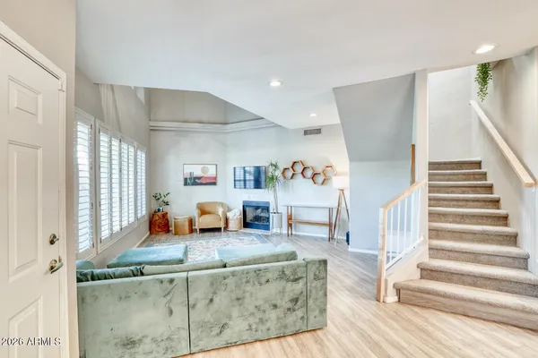 a living room with furniture and a wooden floor