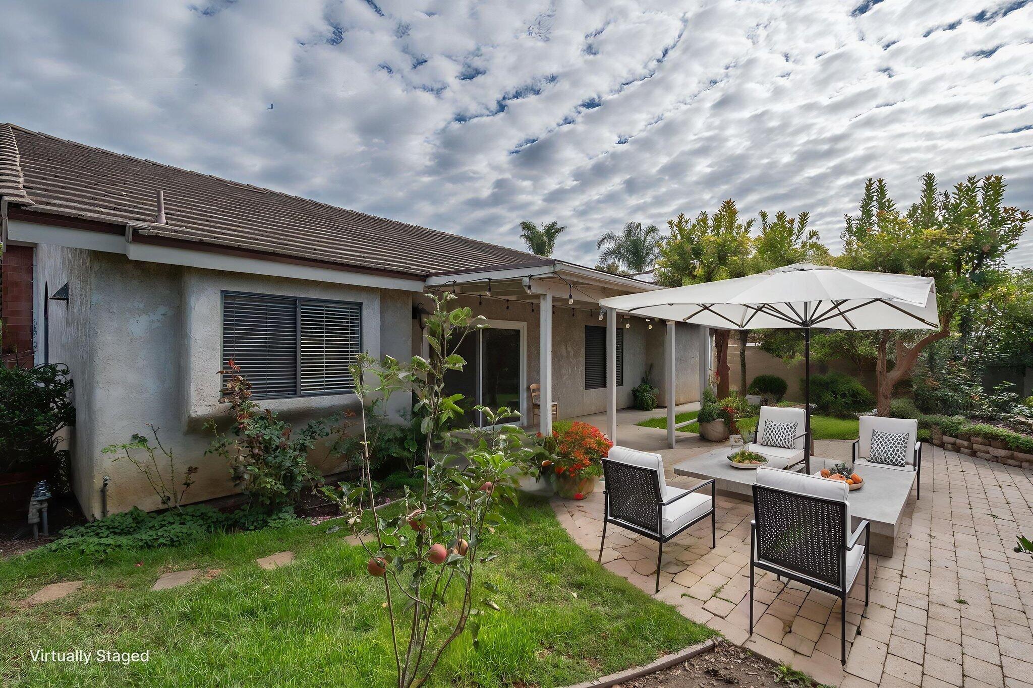2363 Seagull Avenue Ventura, CA 93003 - Photo 11 of 37 a patio with a table and chairs under an umbrella