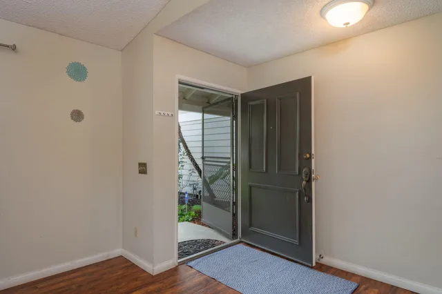 a view of an entryway with wooden floor