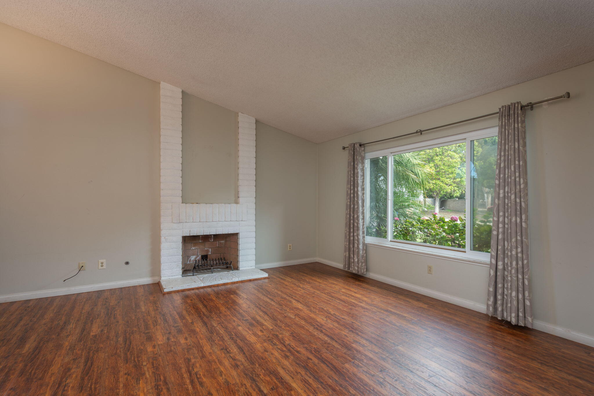 2363 Seagull Avenue Ventura, CA 93003 - Photo 15 of 37 an empty room with wooden floor fireplace and windows