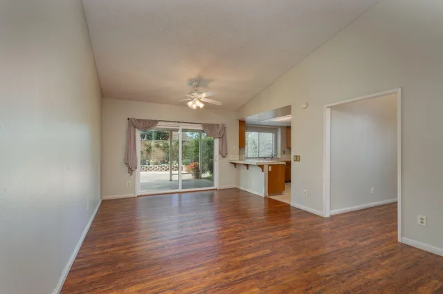 a view of empty room with wooden floor and fireplace
