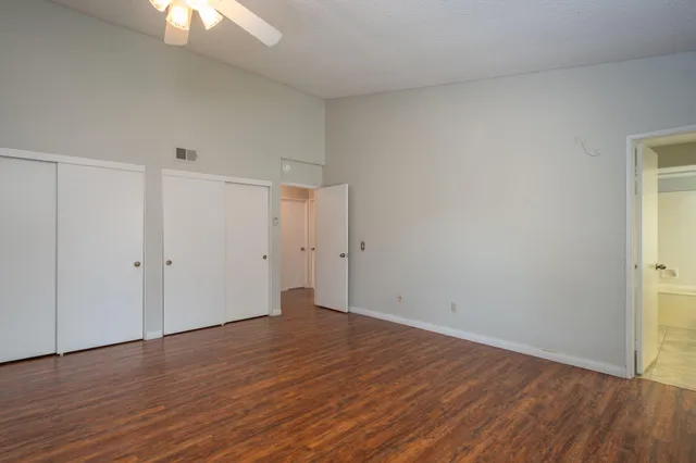 a view of an empty room with wooden floor