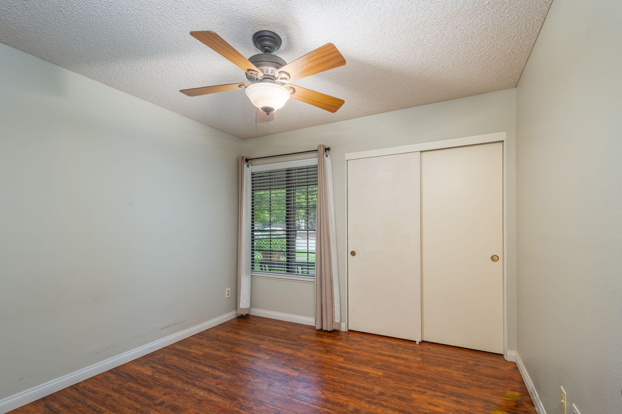 2363 Seagull Avenue Ventura, CA 93003 - Photo 23 of 37 an empty room with wooden floor fan and windows